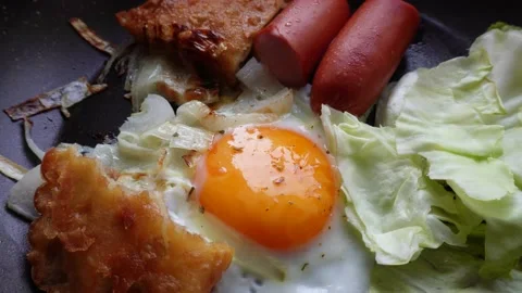 Fried egg with sausage in a pan for breakfast 4k Video stock 180376072