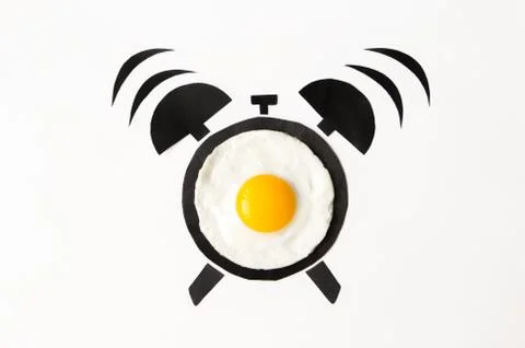 Fried egg in shape of alarm clock, breakfast time concept Stock Photos