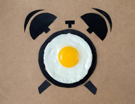 Fried egg in shape of alarm clock, breakfast time concept Stock Photos