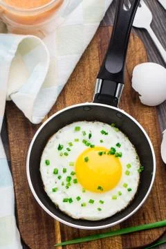 Fried egg in a small pan Stock Photos