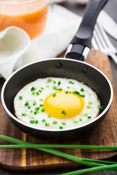Fried egg in a small pan Stock Photos