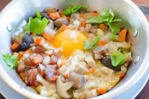 Fried egg stuff with hot pan, traditional breakfast of thai people Stock Photos