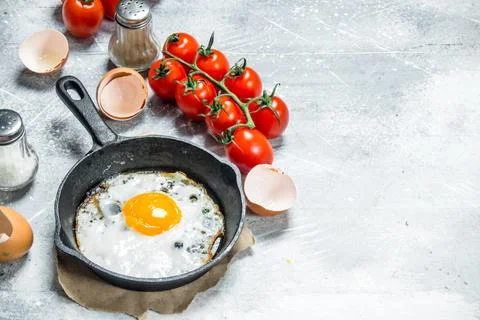 Fried egg with tomatoes. Stock Photos
