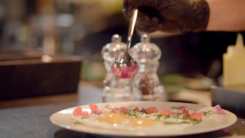 Fried egg topped with chopped onion and served in restaurant Stock Footage 99398216