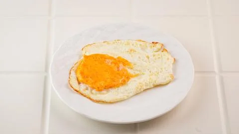 Fried egg on white plate for breakfast Foto stock