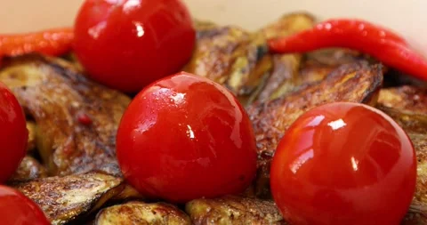 Fried eggplant with tomatoes, pepper close up Stock Footage 133457801
