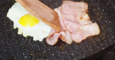 Fried Eggs And Bacon In A Pan Stock Footage 144012644