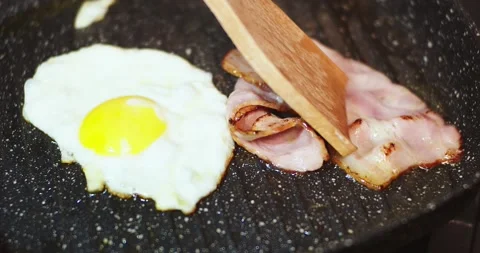 Fried Eggs And Bacon In A Pan Stock Footage 144012647