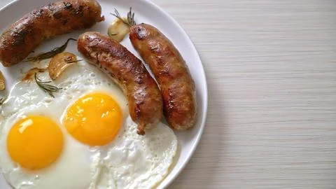Fried eggs and bacon on a white plate for breakfast Stock Photos