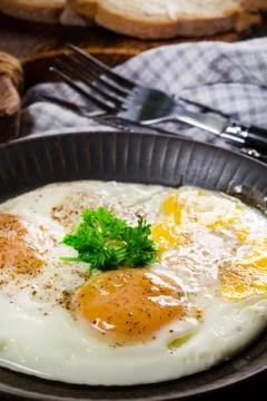 Fried eggs and brea. Stock Photos