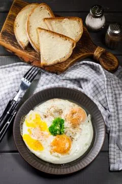 Fried eggs and brea. Stock Photos