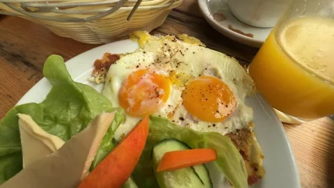 Fried Eggs and Fresh Salad Served with Orange Juice on Rustic Breakfast Table Stock Footage 341699713