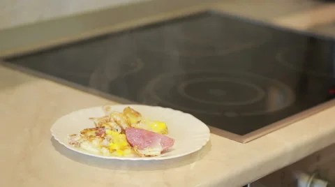 Fried eggs and ham in a pan for breakfast. Cooking Stock Footage