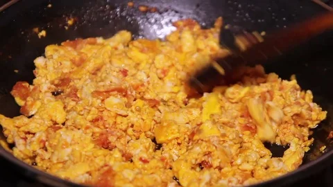 Fried Eggs And Tomatoes Mixing Stock Footage 79493011