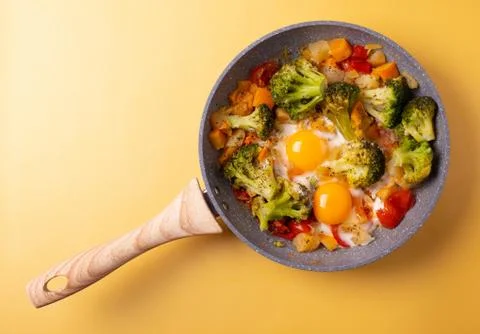 Fried eggs and vegetables Stock Photos
