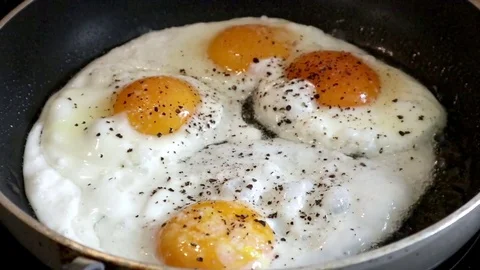 Fried eggs are fried in a frying pan. Stock Footage 76184350