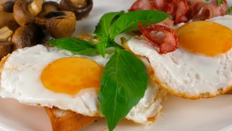 Fried eggs with bacon and mushrooms, close-up view, served in Restaurant Stock Footage 87405363
