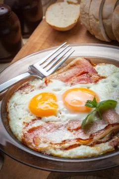 Fried eggs with bacon. Stock Photos