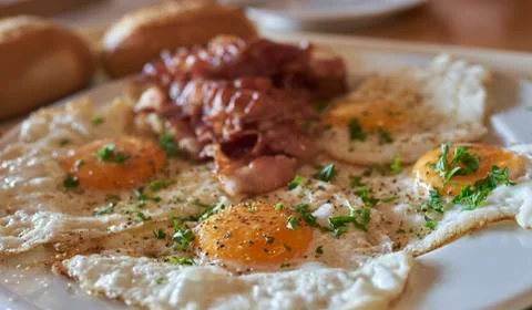 Fried eggs with bacon Stock Photos