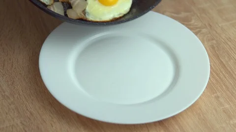 Fried eggs with bacon on a plate Stock Footage 100234613
