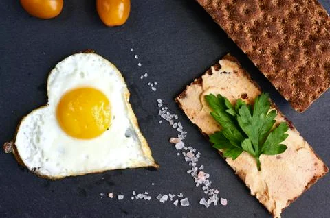 Fried eggs with bread on a black background Stock Photos