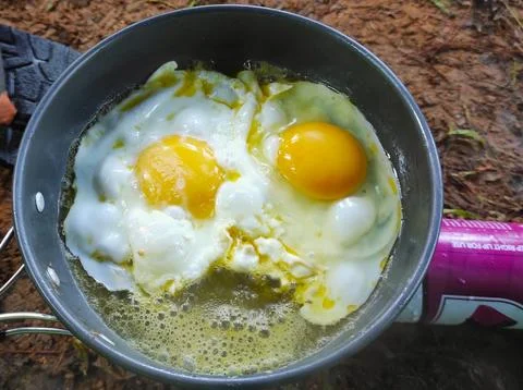Fried eggs for breakfast in outdoor activity Stock Photos