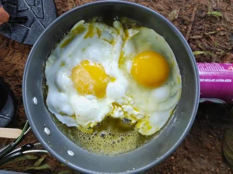 Fried eggs for breakfast in outdoor activity Stock Photos