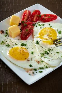 Fried eggs with cherry tomatoes and cheese 스톡 사진