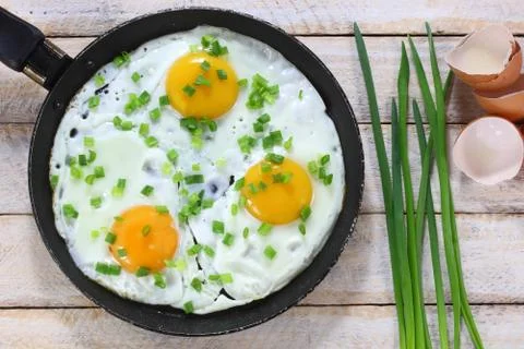 Fried eggs with chives Stock Photos