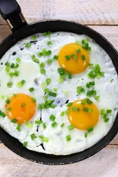 Fried eggs with chives Stock Photos