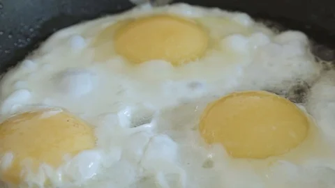 The fried eggs cooked on a pan close up Stock Footage 108000213