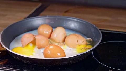 Fried Eggs Cooked in a Pan with Cracked Shells Displayed Beautifully for the Stock Footage 281125627