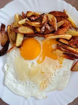 Fried Eggs with Crispy Potatoes Stock Photos