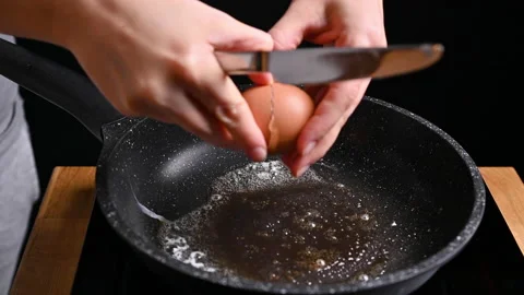 Fried eggs in a frying pan. The egg is fried in butter. High quality 4k footage Stock Footage 145697415