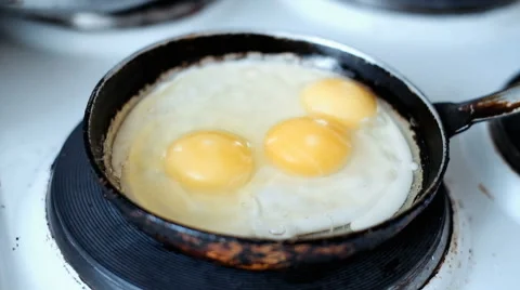 Fried eggs in a frying pan Stock Footage 64165259