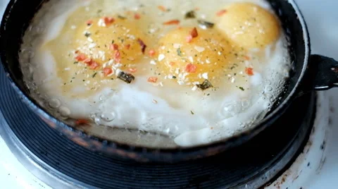 Fried eggs in a frying pan Stock Footage 64165756