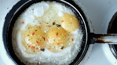 Fried eggs in a frying pan Stock Footage 64165928