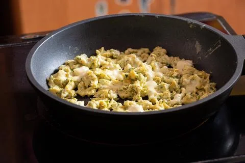 Fried eggs in a frying pan in the kitchen on an induction stove Stock Photos