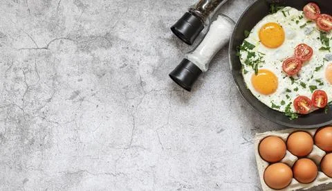 Fried eggs in a frying pan. Stock Photos