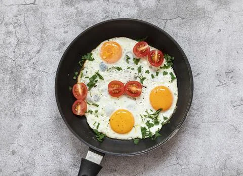 Fried eggs in a frying pan. Stock Photos