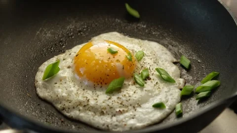 Fried with eggs green onion on a pan. tasty breakfast Stock Footage 317043952