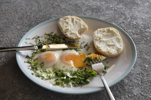Fried eggs with greens close-up Фото