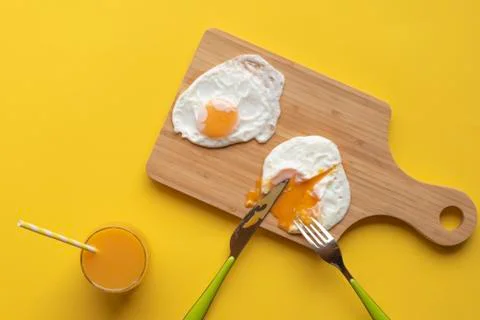 Fried eggs on a kitchen table Stock Photos