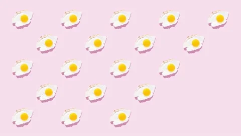 Fried eggs on a light pink background, pattern. Stock Footage 148824616