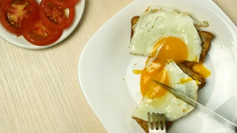 Fried eggs lying on toasted bread. Stock Footage 130673561