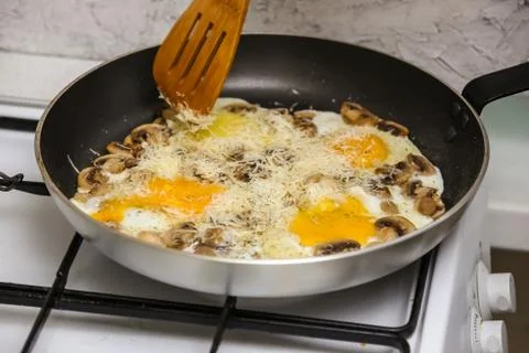 Fried eggs with mushrooms for a breakfast Stock Photos