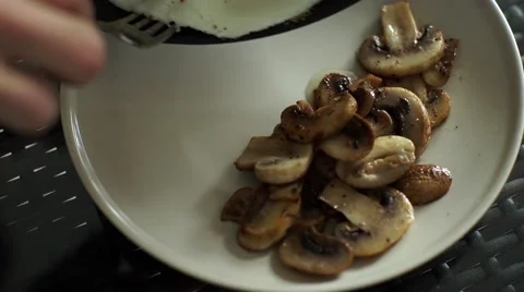 Fried eggs with mushrooms Stock Footage 56260371