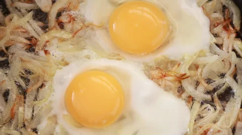 Fried eggs with onions Stock Footage 34759842