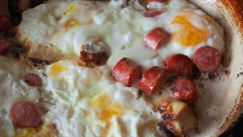 Fried eggs in a pan in hot oil close up Stock Footage 112219244