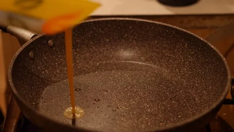 Fried eggs in a pan. Omelette from a scrambled eggs. 60 to 24fps UHD 4K Stock Footage 74344871